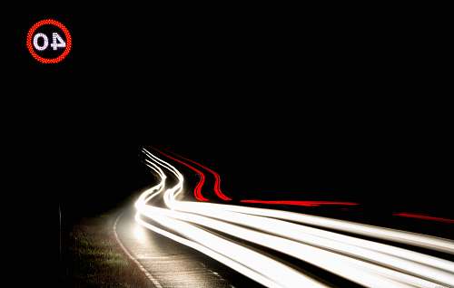 night time long-exposure photography of light streaks on road during nighttime car light